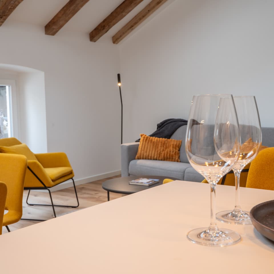 Das gemütliche Wohnzimmer hat einen offenen Grundriss, der den Blick auf die Holzbalken im Dach freigibt.