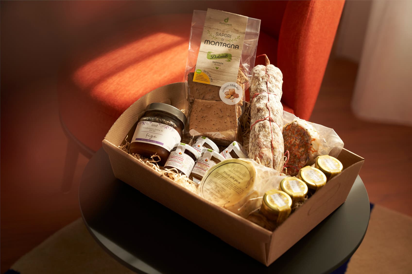 A basket presenting local specialities from Trieste, such as fig marmelade, cheese and sausage.